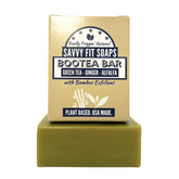 A box of Savvy Fit Soaps Bootea Bar in Green Tea, Ginger, and Alfalfa with an open soap, highlighting its plant-based, USA-made, and invigorating skincare formula.
